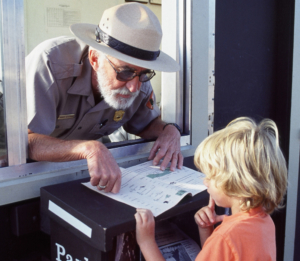 A man in a hat looking at a boy.