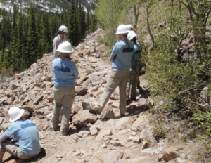 A group of people on a rocky trail.