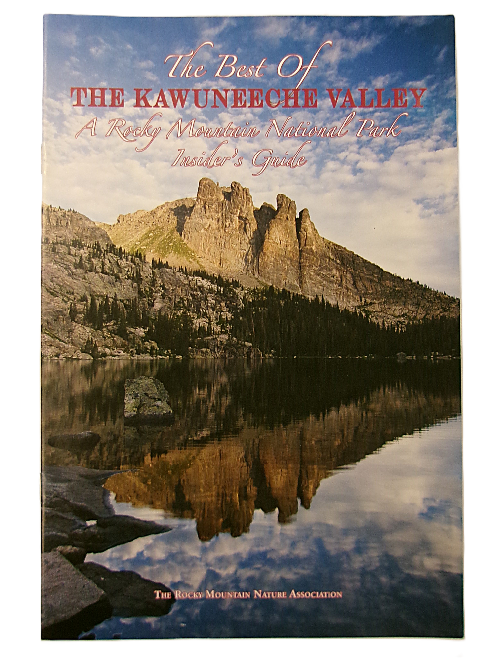 best of kvc Cover of "The Best of the Kawuneeche Valley: A Rocky Mountain National Park Insider’s Guide" shows a rocky mountain landscape mirrored in a tranquil lake beneath a partly cloudy sky.