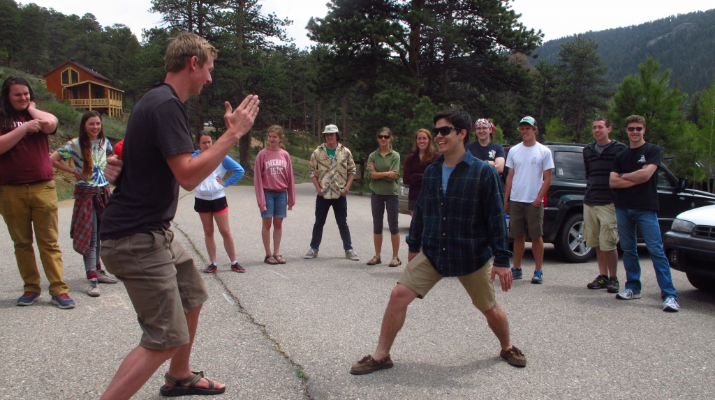 A group of people playing a game of frisbee.