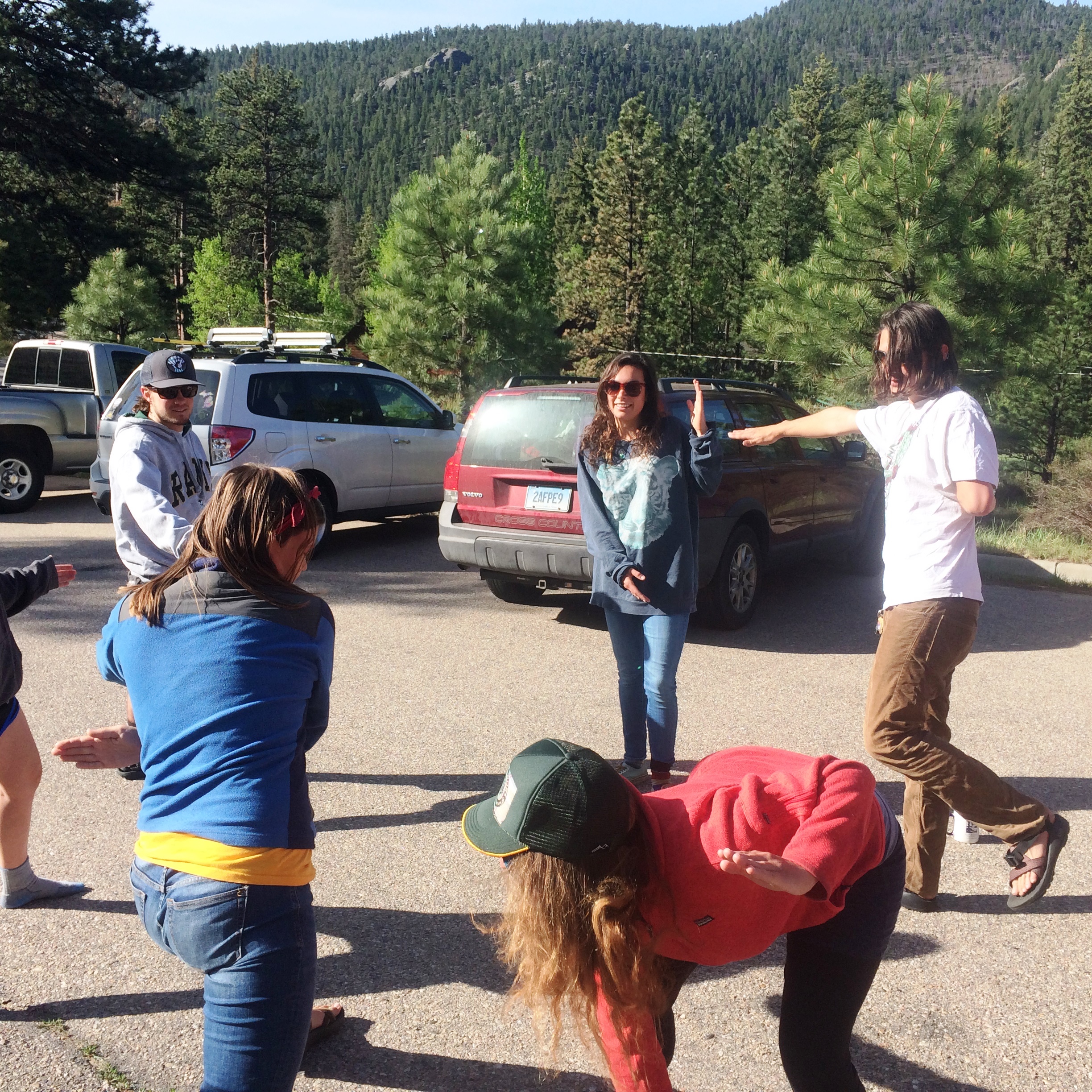 Group of people chatting and stretching in a parking area