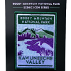 KVC Patch The Patch - RMNP Kawuneeche Valley shows a purple and green landscape with a river and a white animal, featuring Rocky Mountain National Park's Kawuneeche Valley. Part of the "Scenic Icon Series.