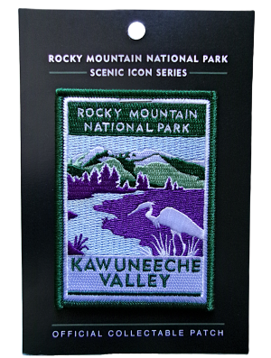The Patch - RMNP Kawuneeche Valley shows a purple and green landscape with a river and a white animal, featuring Rocky Mountain National Park's Kawuneeche Valley. Part of the "Scenic Icon Series.