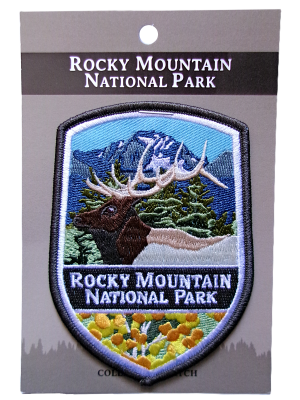 An embroidered Rocky Mountain National Park patch with a Rocky Mountain elk, trees, and mountains on a mounting card is titled "Patch - RMNP.