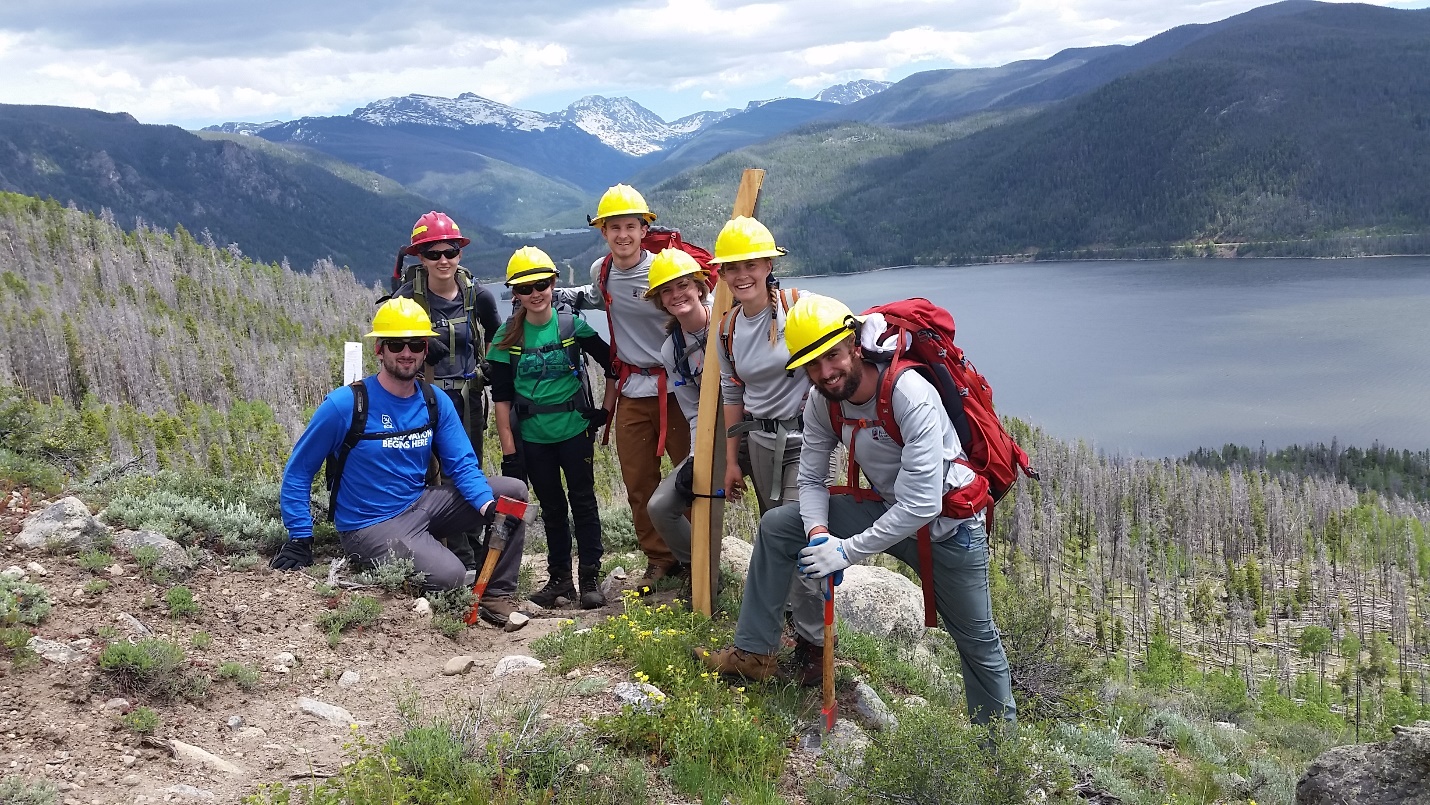 Group of hikers posing for a picture before climbing the mountain