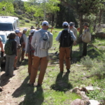 A group of people walking down a trail.