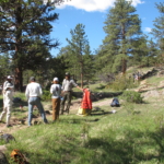 A group of people standing on a trail.