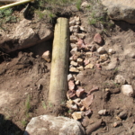 A man is digging a hole in the ground.