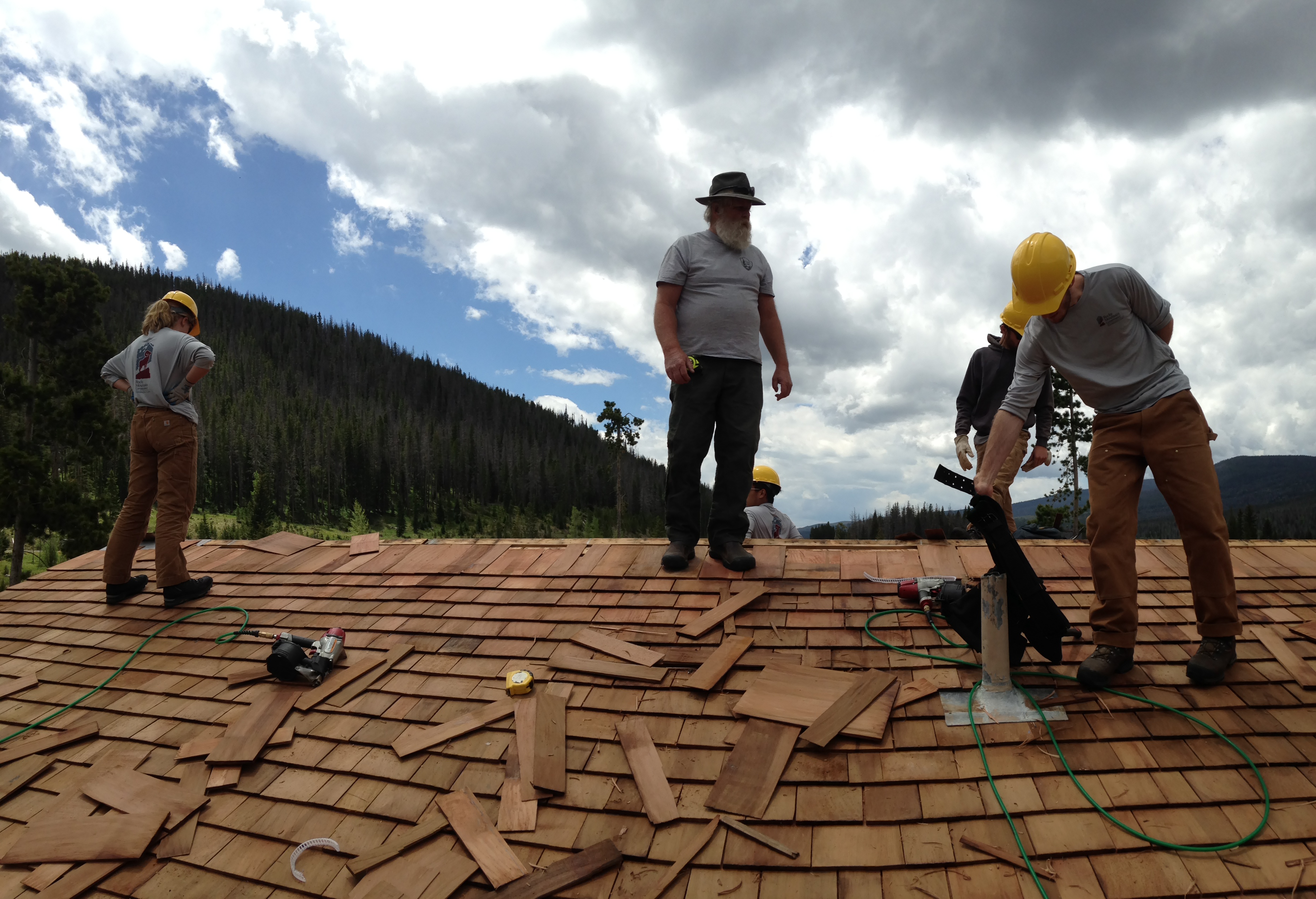 Workers fixing a bricked roof