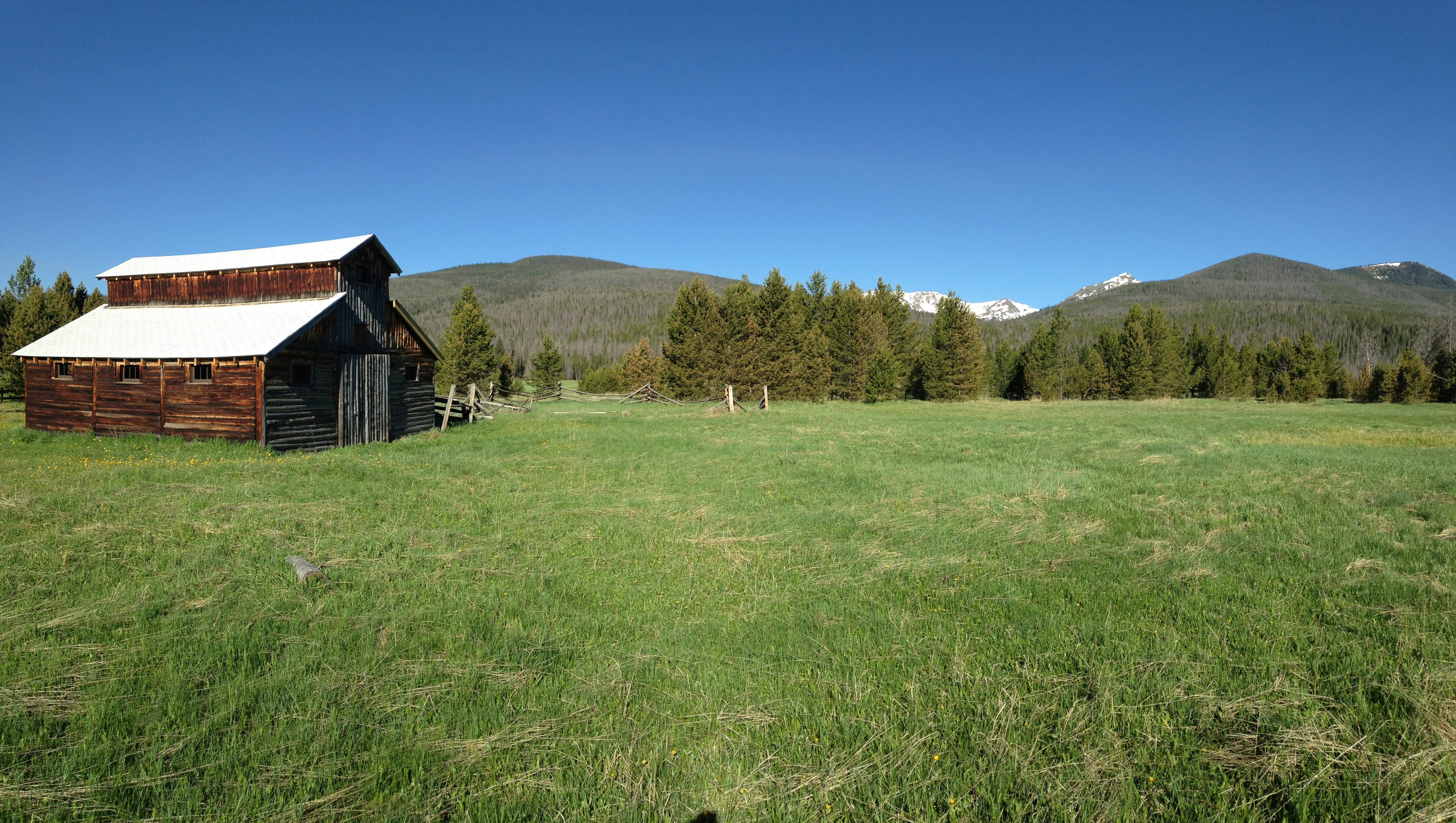 A barn on vast green field of grass