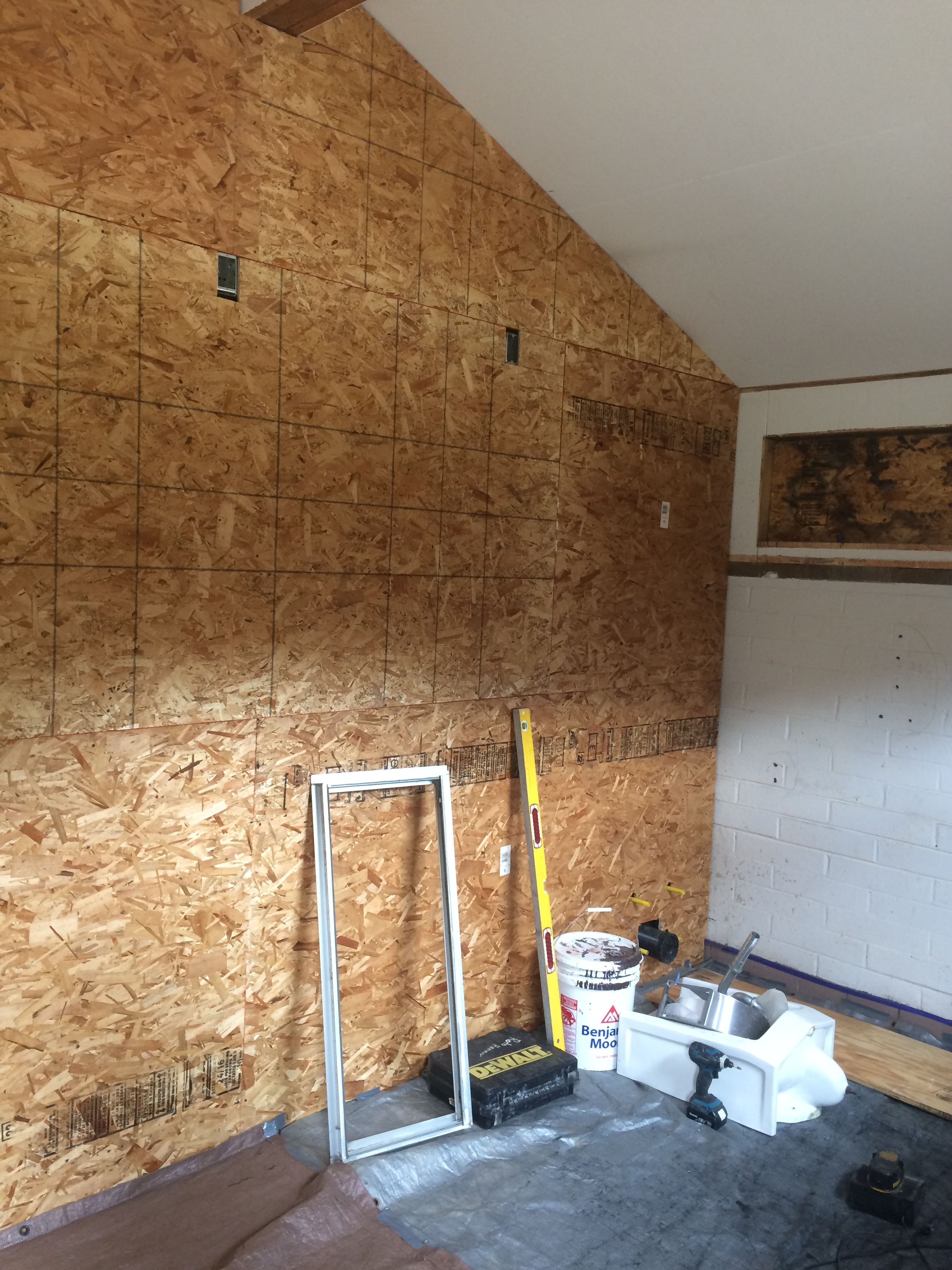 Interior of a room under construction with exposed wooden particle board walls