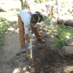 A man digging a hole in the ground.