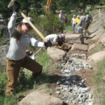 A group of people working on a trail.