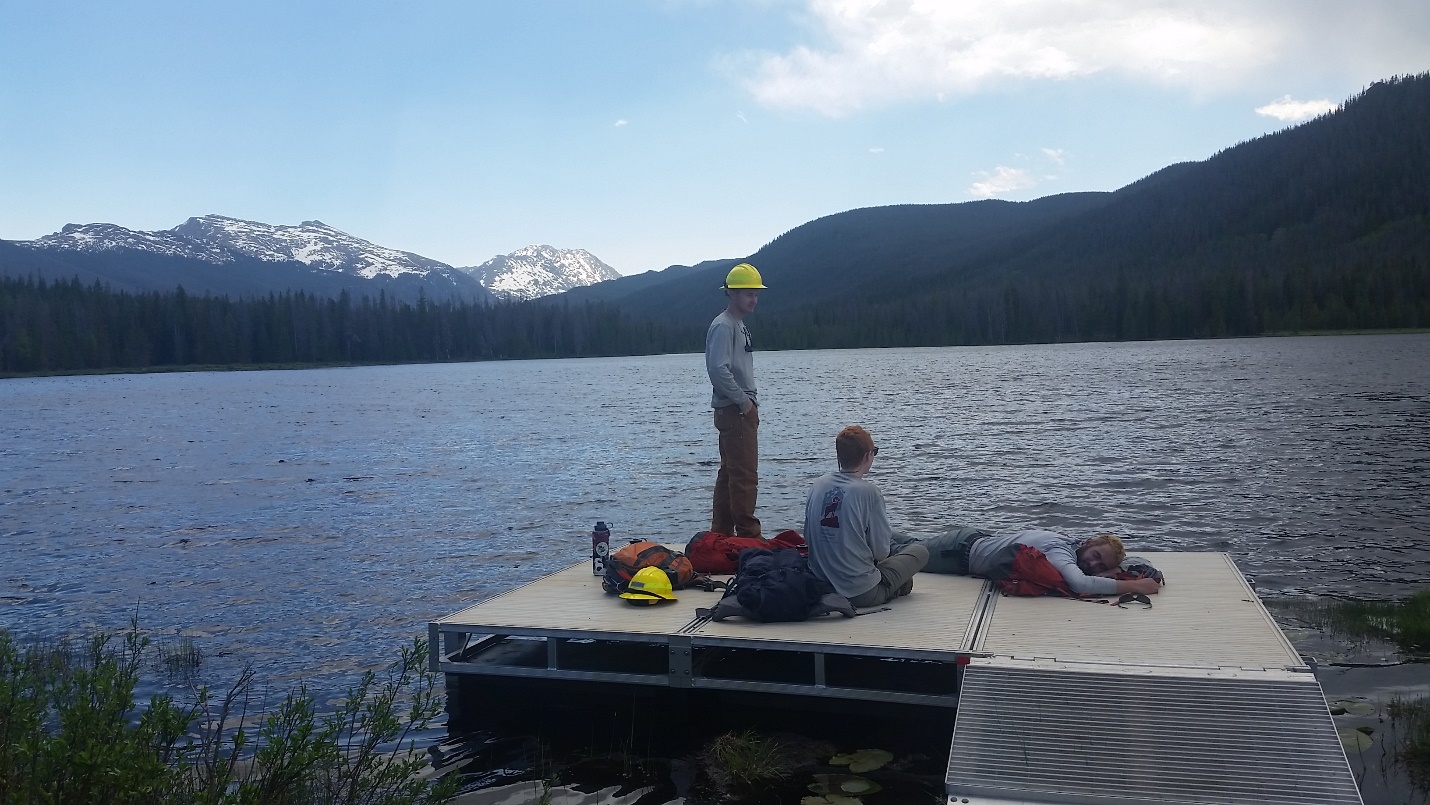 Workers resting beside a lake
