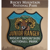 JR Ranger Junior Ranger patch featuring a ram design for Rocky Mountain National Park, presented on a brown card with "Explore • Learn • Protect.