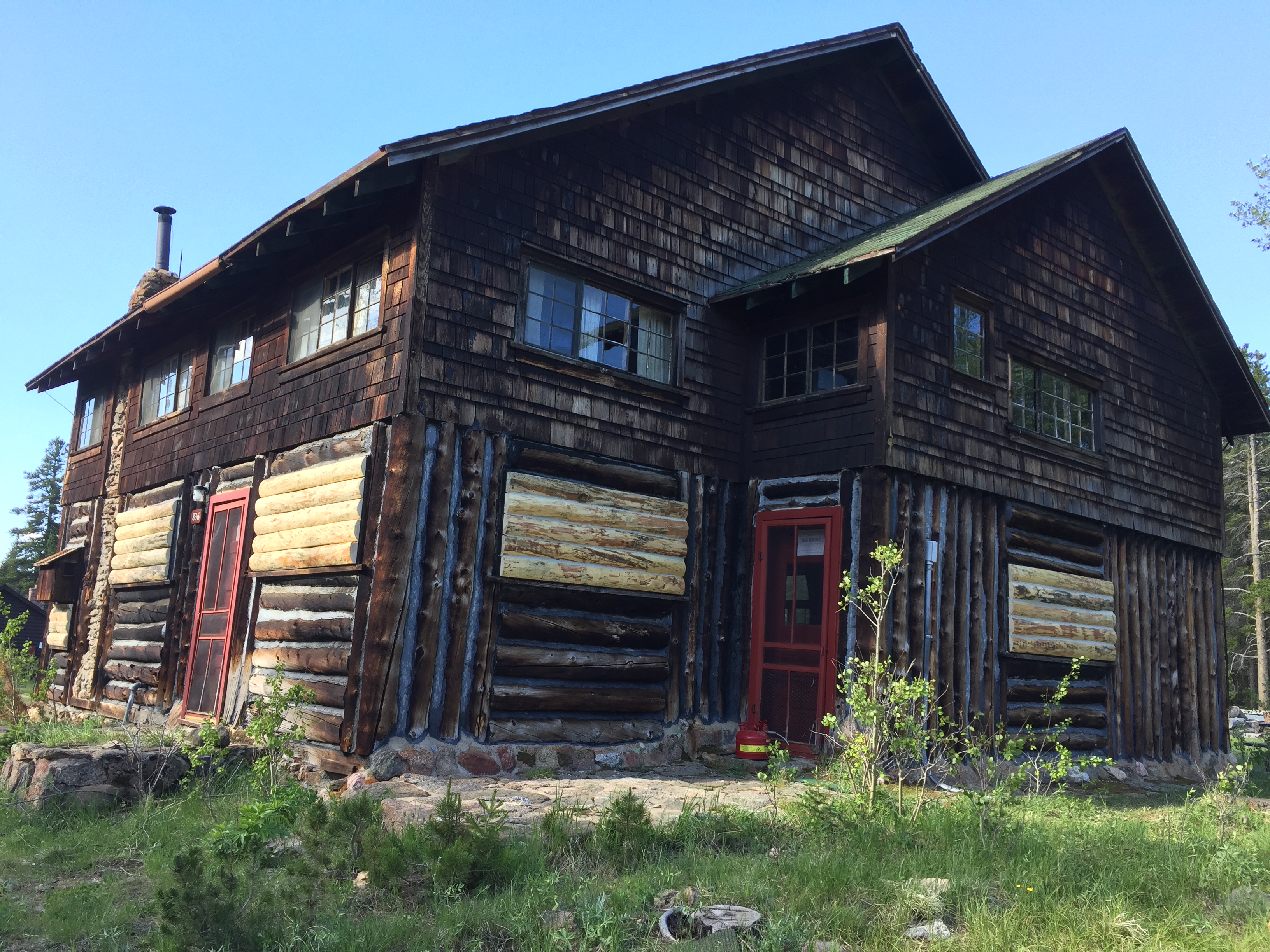 A rustic log cabin with a dark brown finish