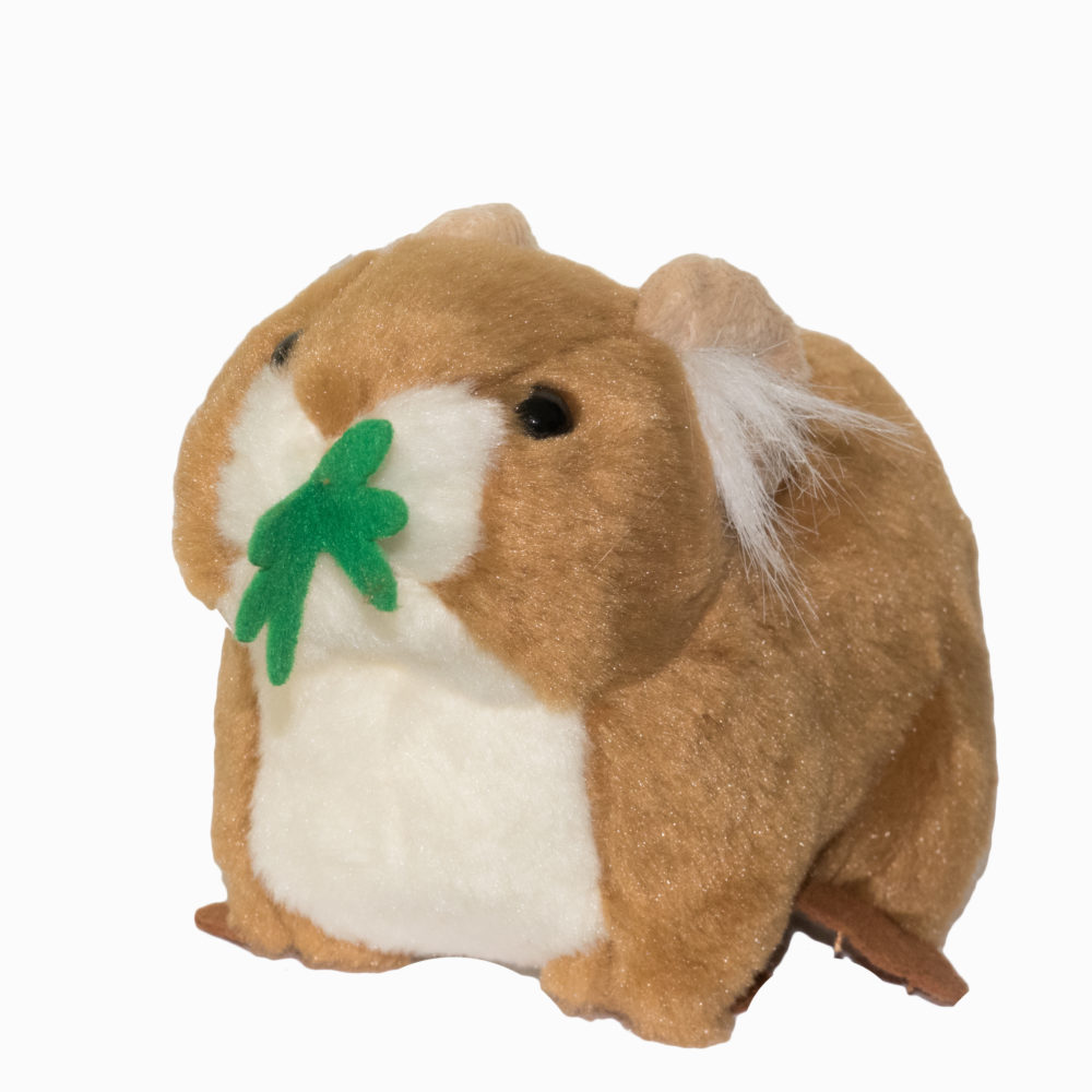 A stuffed Pika with a green leaf on its head.