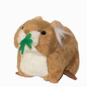 A stuffed Pika with a green leaf on its head.