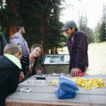 A group of people standing around a table.