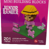 Box of "Junior Ranger Pink" mini building blocks with a figure, hat, sign, dog, and trees on a green base. Includes 201 pieces for ages 7+.