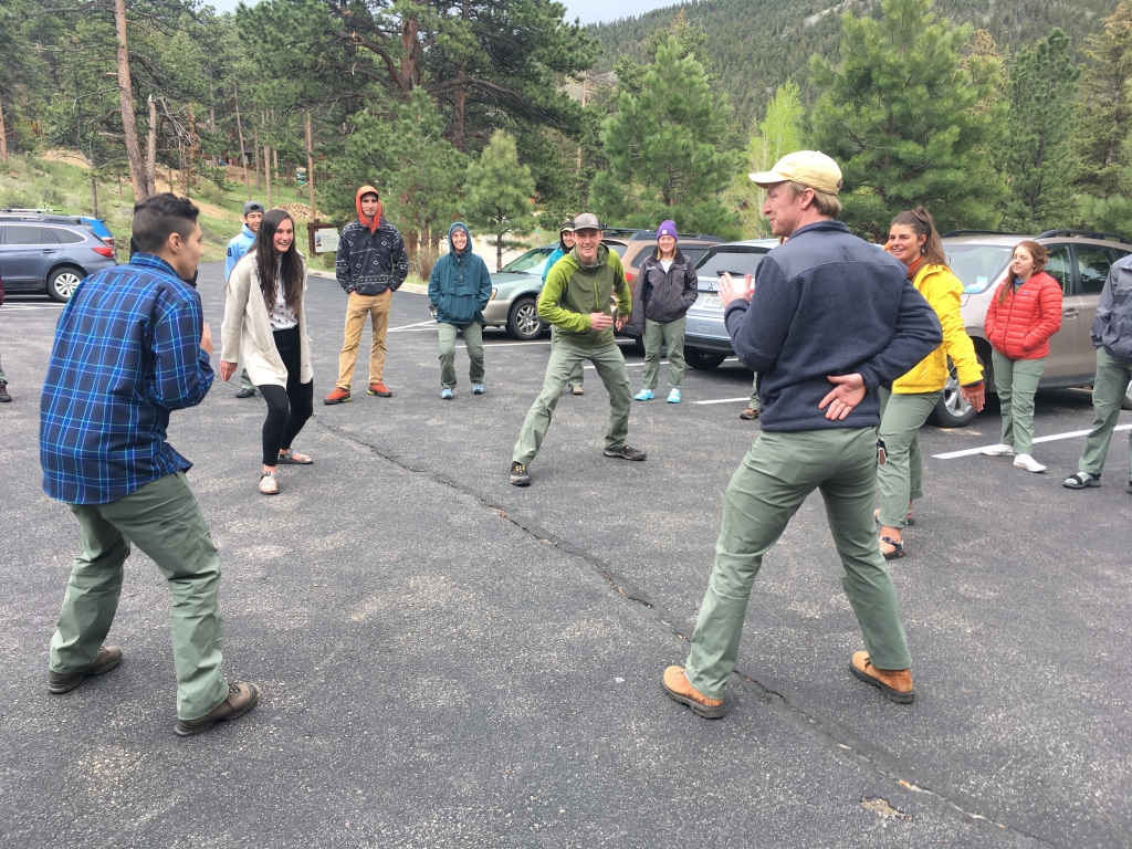 A group of people playing frisbee in a parking lot.