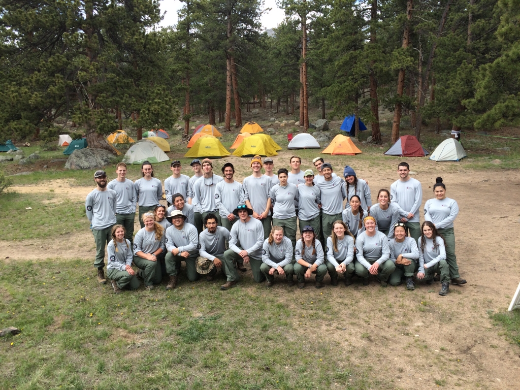 A group of people posing in front of tents.