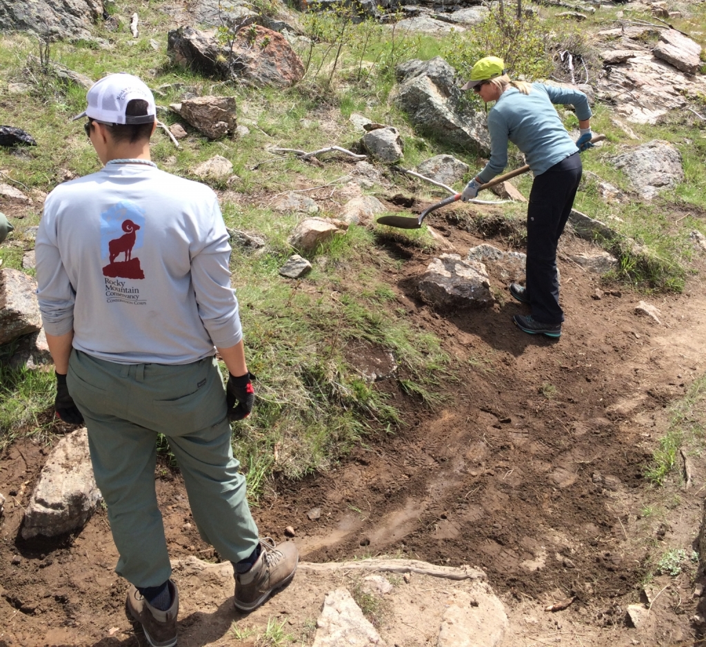 Two people working on a trail.