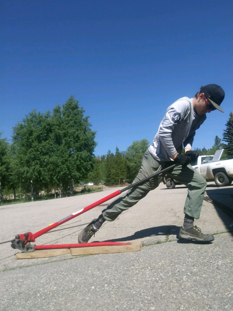 A man is using a shovel to dig a hole in the ground.