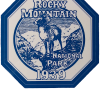 Hexagonal blue and white badge sticker featuring a ram, mountains, and the text "Rocky Mountain National Park 1939" from Sticker - RMNP Historic Park.