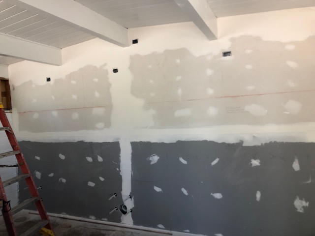 A room is being remodeled with drywall and paint.