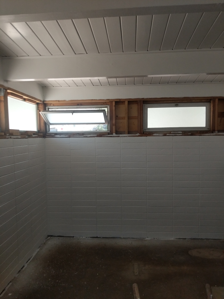 A room with white walls and a window.