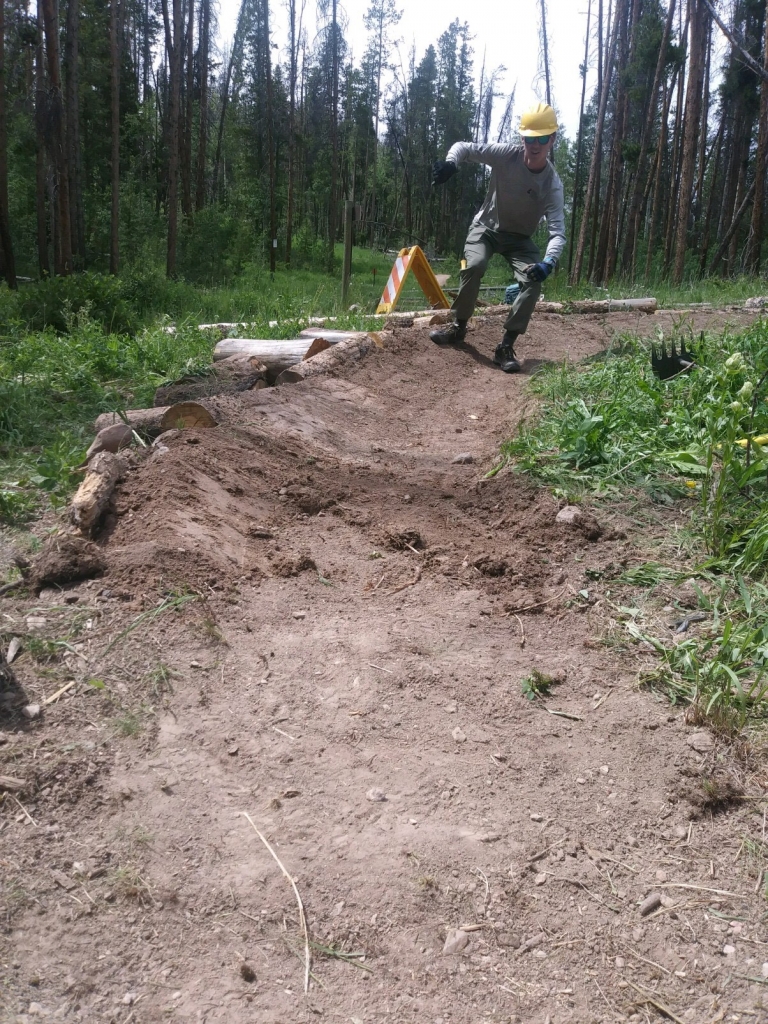 A man riding a bike on a dirt trail.