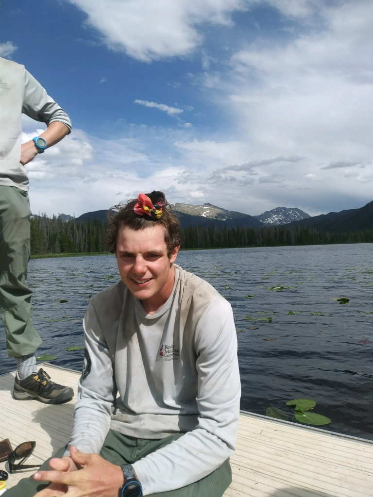 Two men sitting on a dock.