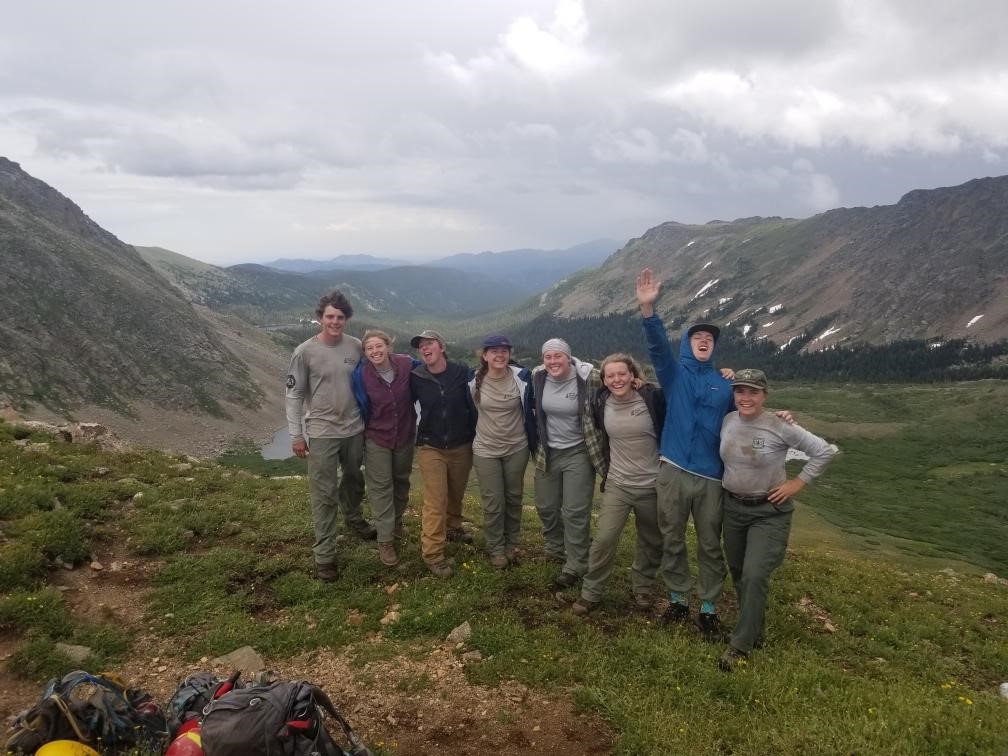 A group of people standing on top of a mountain.