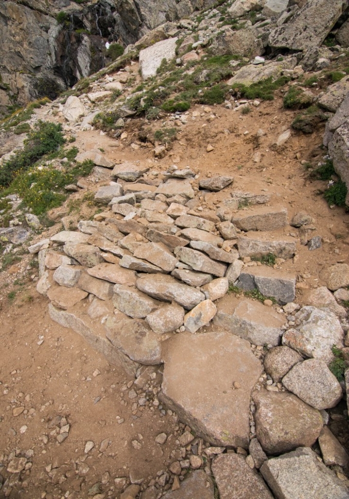 A rocky path leading up to a waterfall.