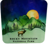 The Coaster - RMNP Blue Moon Elk features an illustration of Rocky Mountain National Park with a deer silhouette, green mountains, trees, and a setting sun.