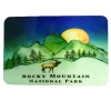 Rocky Mountain National Park illustration on the Magnet - RMNP Night Sky Elk features mountains, a setting sun, trees, and an elk in the foreground.