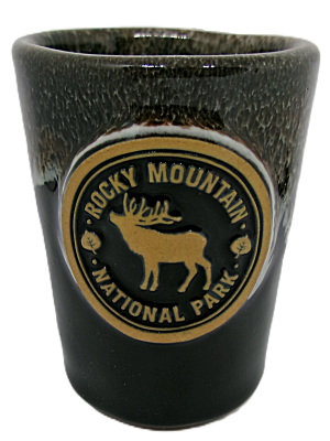 Black ceramic shot glass featuring the Rocky Mountain National Park emblem with an elk and text.
