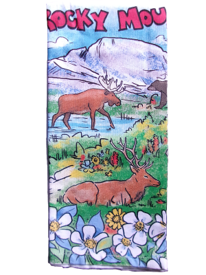 Colorful tea towel with a variety of animals and flowers.
