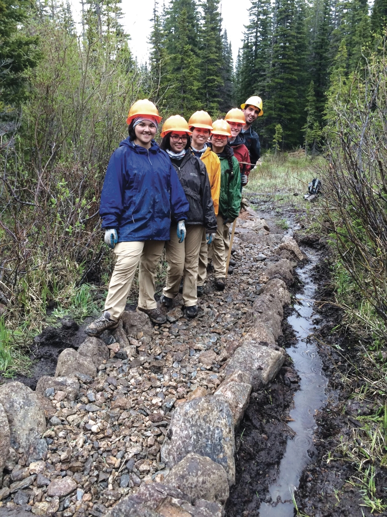 A group of people standing on a rocky path.