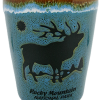 Shot glass with a silhouette of an elk, sun, and "Rocky Mountain National Park" text on a blue and green speckled background.