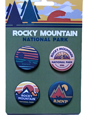 The Button Collection - RMNP Olive features four pins with mountain and sun designs on a cardboard backing.