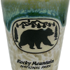 Green Bear Shot glass showcasing a black bear silhouette with "Rocky Mountain National Park" text, featuring a green and brown glaze.