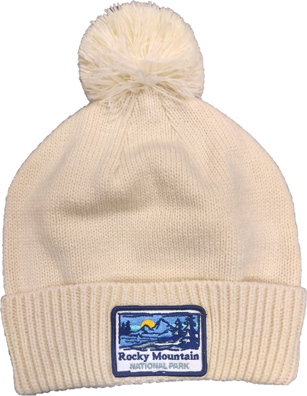Ivory BEanie A white beanie with a mountain patch on it.