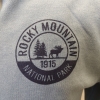 Rocky Mountain National Park logo on a RMNP Zip-Up Blue sweatshirt.