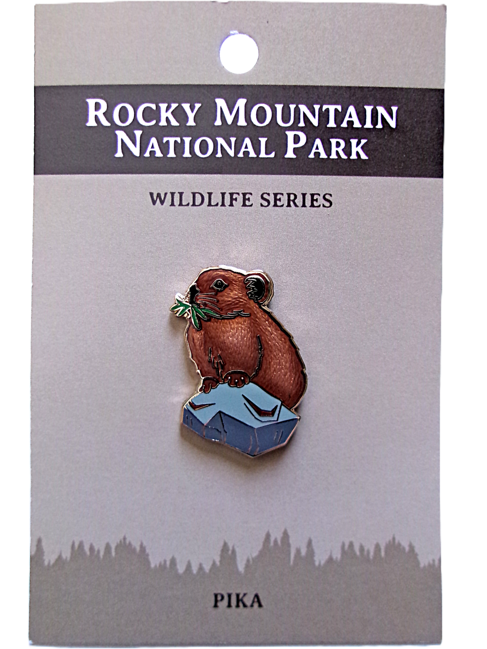 Enamel pin from the RMNP North American Wildlife Series featuring a pika holding grass, presented on a branded card.