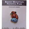 Enamel pin from the RMNP North American Wildlife Series featuring a pika holding grass, presented on a branded card.