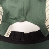 Close-up of the inside of a Hat - RMNP Green Camper showing the black adjustable strap and the tag with "LOCALE" written on it.