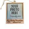 Ornament - Wooden Picture Frame with Aspen Leaf, featuring a string for hanging and labeled "Rocky Mountain National Park," displays the placeholder text "YOUR PHOTO HERE" with "The Trendy Traveler" branding.