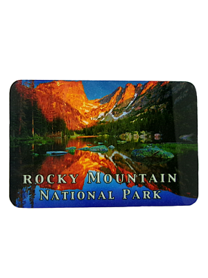 A scenic image of Dream Lake in Rocky Mountain National Park at sunset reflects mountains and trees. Text reads "Rocky Mountain National Park." Product Name: Magnet - RMNP Dream Lake.